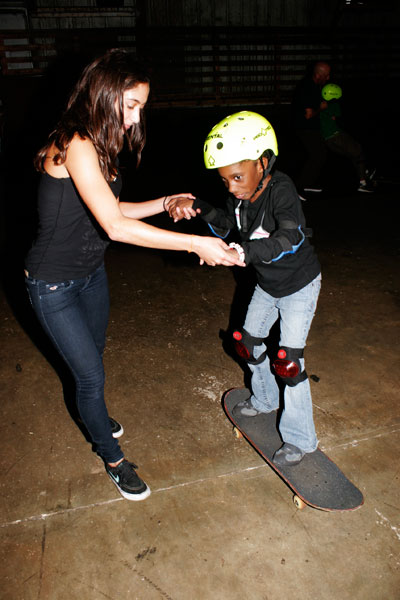 Alex Biblioni helping a girl get on a board